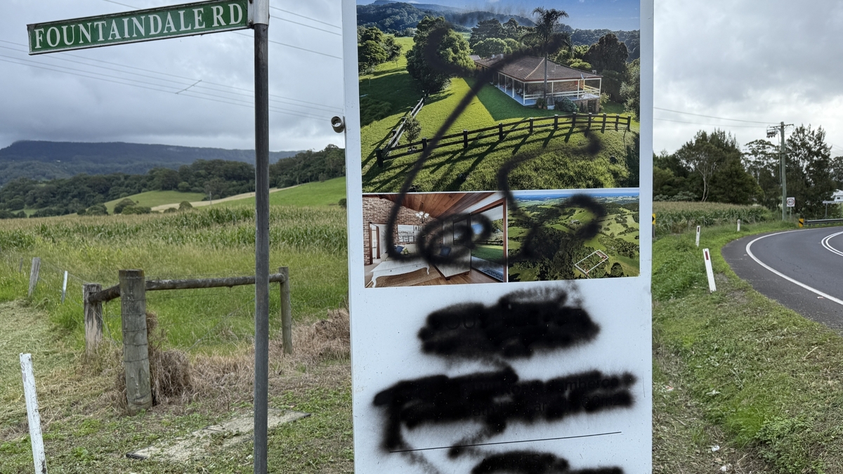 Vandalised real estate sign sparks questions in Kiama